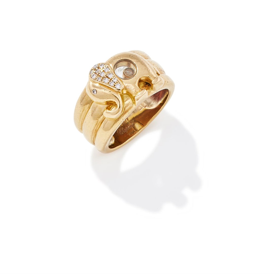 CHOPARD, A 'HAPPY DIAMONDS' DRESS RING: CHOPARD, A 'HAPPY DIAMONDS' DRESS RINGDesigned as an elephant with pavé set brilliant cut diamond ear, to a circular glazed compartment containing a floating diamond, to a reeded shank, signed