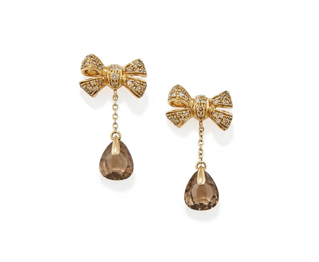 POMELLATO, A PAIR OF DIAMOND AND SMOKY QUARTZ 'FOREVER' EARRINGS: POMELLATO, A PAIR OF DIAMOND AND SMOKY QUARTZ 'FOREVER' EARRINGSEach bow surmount set throughout with brilliant cut diamonds of brown tint, suspending a fancy cut smoky quartz drop on a chain