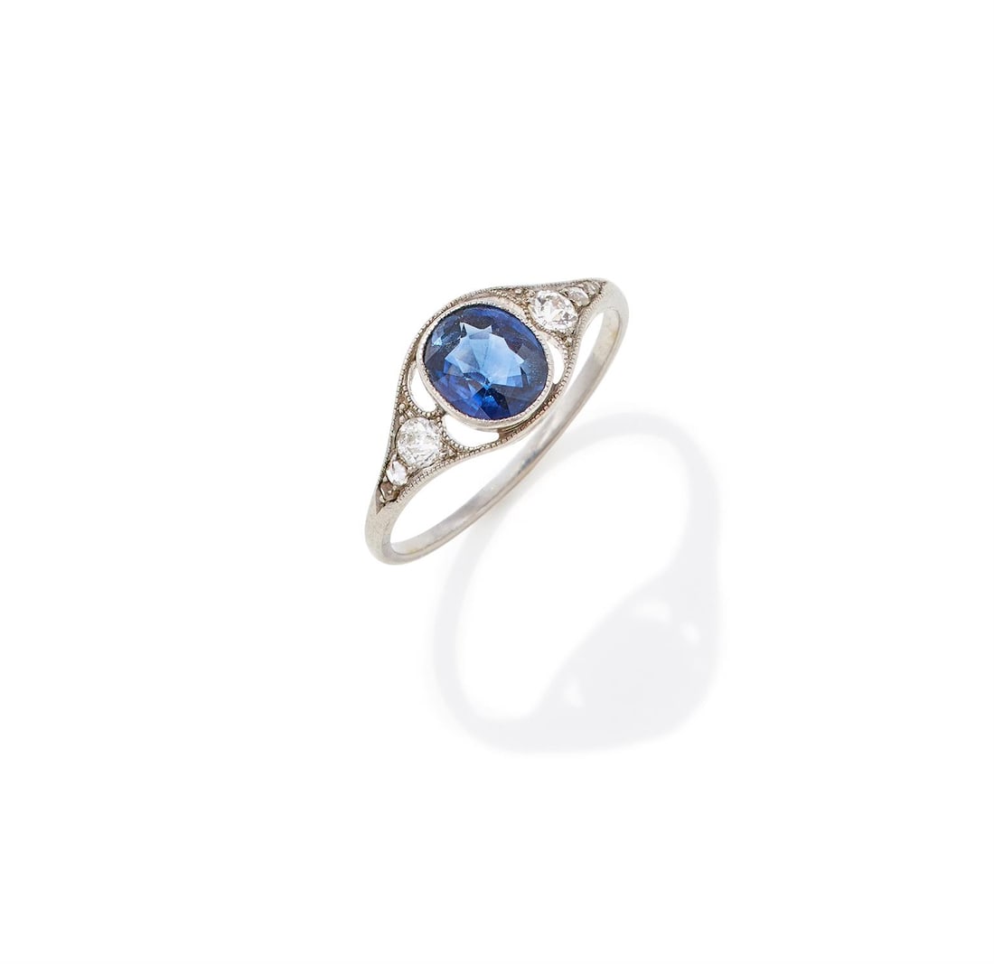 AN ART NOUVEAU SAPPHIRE AND DIAMOND RING: AN ART NOUVEAU SAPPHIRE AND DIAMOND RING CIRCA 1910 The oval cut sapphire millegrain set between pierced tapered shoulders set with old European and rose cut diamonds, unmarked Size/dimensions: ring s