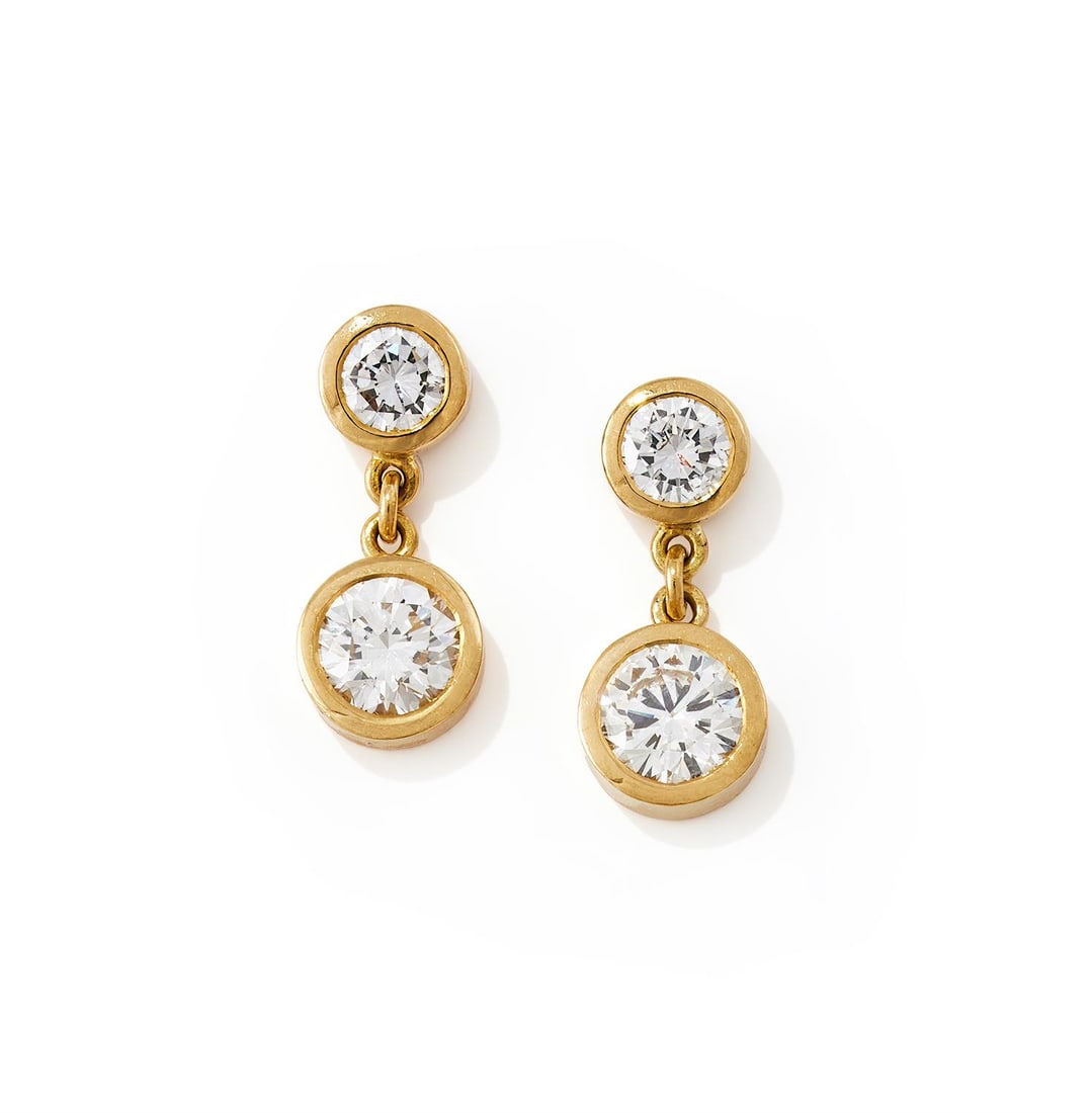 A PAIR OF DIAMOND EARRINGS: A PAIR OF DIAMOND EARRINGSEach collet set brilliant cut diamond suspended from a similarly set surmount, post fittings, unmarkedSize/dimensions: 1.9cm longGross weight: 5.7 grams