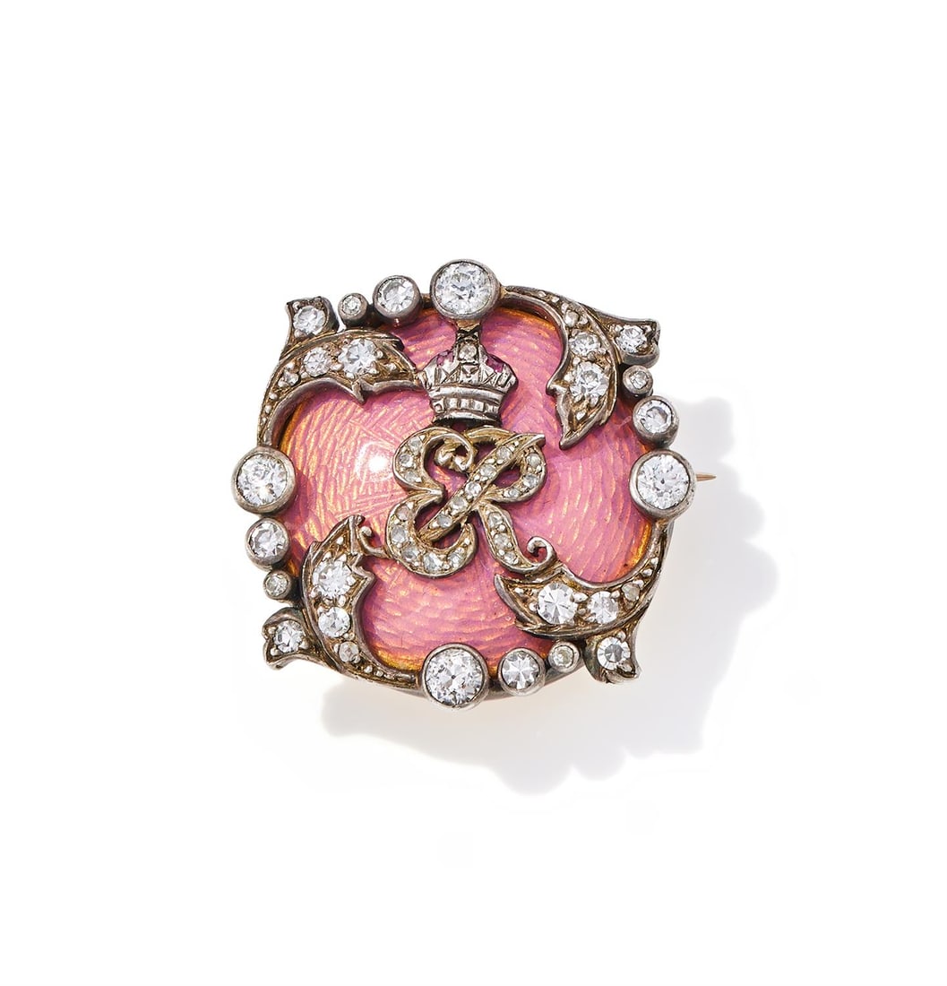 ROYAL INTEREST, AN EDWARDIAN ENAMEL AND DIAMOND BROOCH: ROYAL INTEREST, AN EDWARDIAN ENAMEL AND DIAMOND BROOCH CIRCA 1900With the rose cut diamond cypher ER beneath a ruby set crown for Edward VII, set on a pink guilloché enamel ground, within a folia