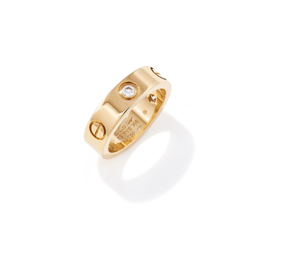 CARTIER, A DIAMOND SET 'LOVE' RING: CARTIER, A DIAMOND SET 'LOVE' RINGThe polished 18ct gold band inset with brilliant cut diamonds between screwhead motifs, signed Cartier, numbered PYE366, maker's mark, European convention and Swiss c