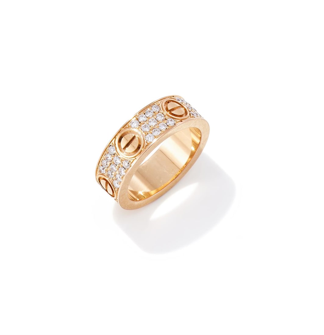 CARTIER, A DIAMOND 'LOVE' RING: CARTIER, A DIAMOND 'LOVE' RINGThe pavé set brilliant cut diamond band with screwhead motifs, signed Cartier, numbered OE6984, stamped 750Size/dimensions: ring size JGross weight: 7.8 grams