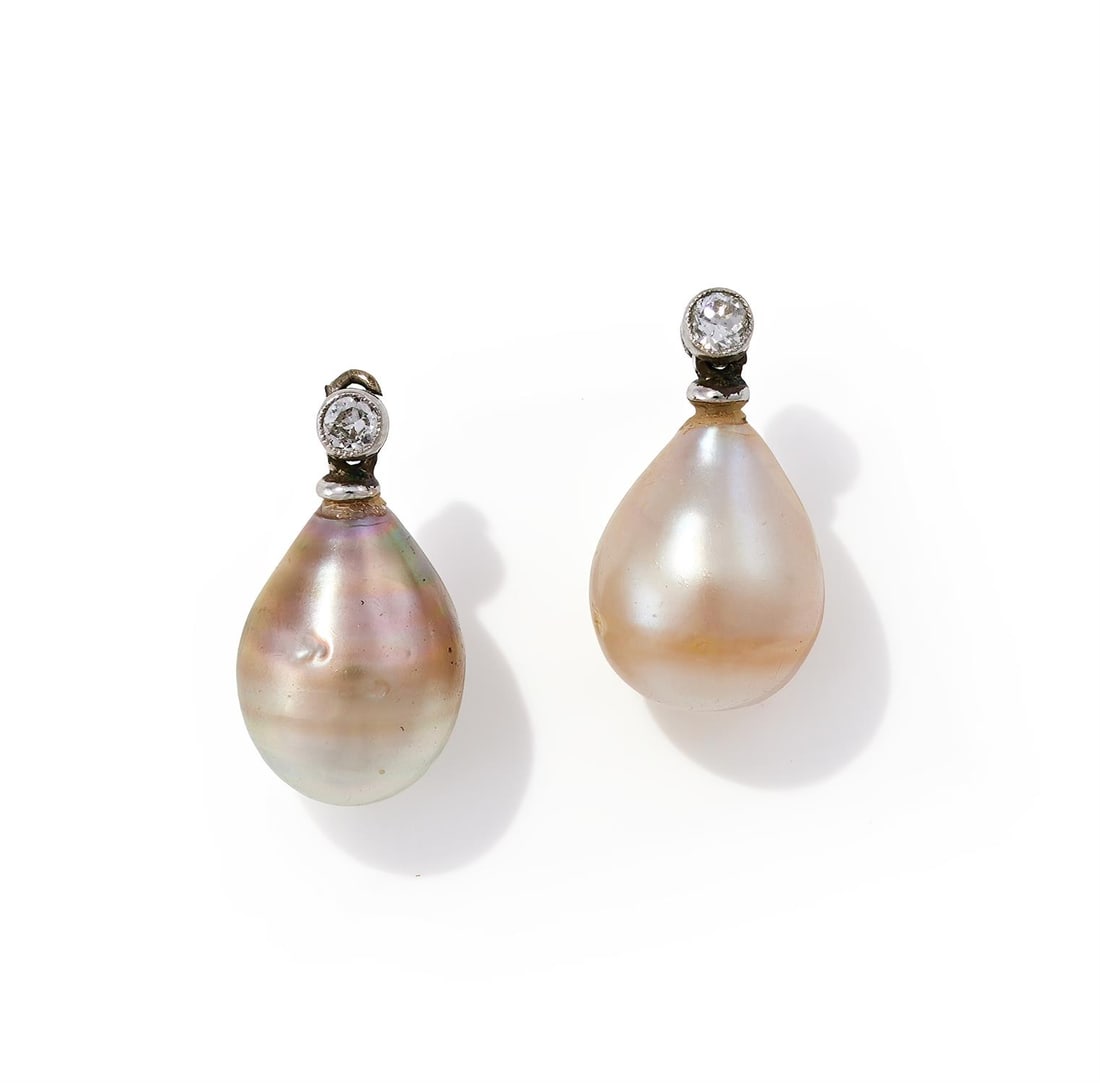 A PAIR OF PEARL AND DIAMOND PENDANTS: A PAIR OF PEARL AND DIAMOND PENDANTS The 12.25 and 12.04mm drop shaped pearls of silver and cream tone with old European cut diamond surmounts Size/dimensions: 1.7cm long Gross weight: 3.1 gramsProven