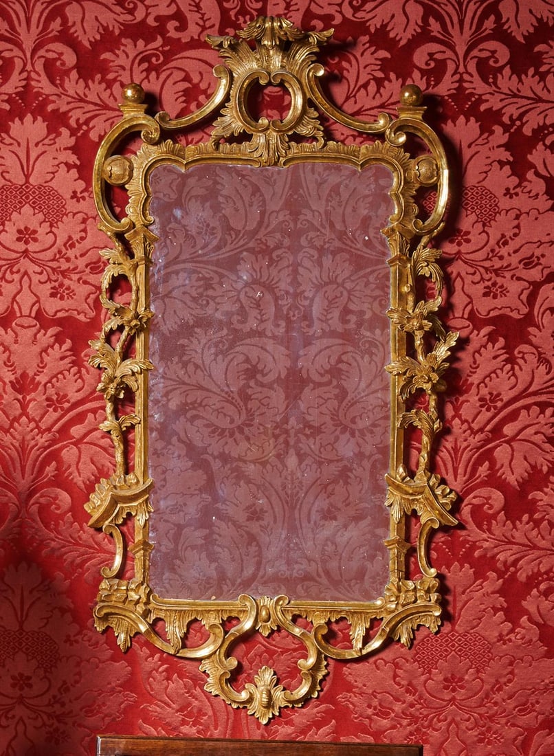 A GEORGE III CARVED GILTWOOD MIRROR, CIRCA 1780 (1 of 3)