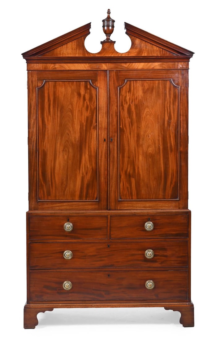 A GEORGE III MAHOGANY LINEN PRESS WITH A CARVED ARCHITECTURAL PEDIMENT, CIRCA 1790 (1 of 3)