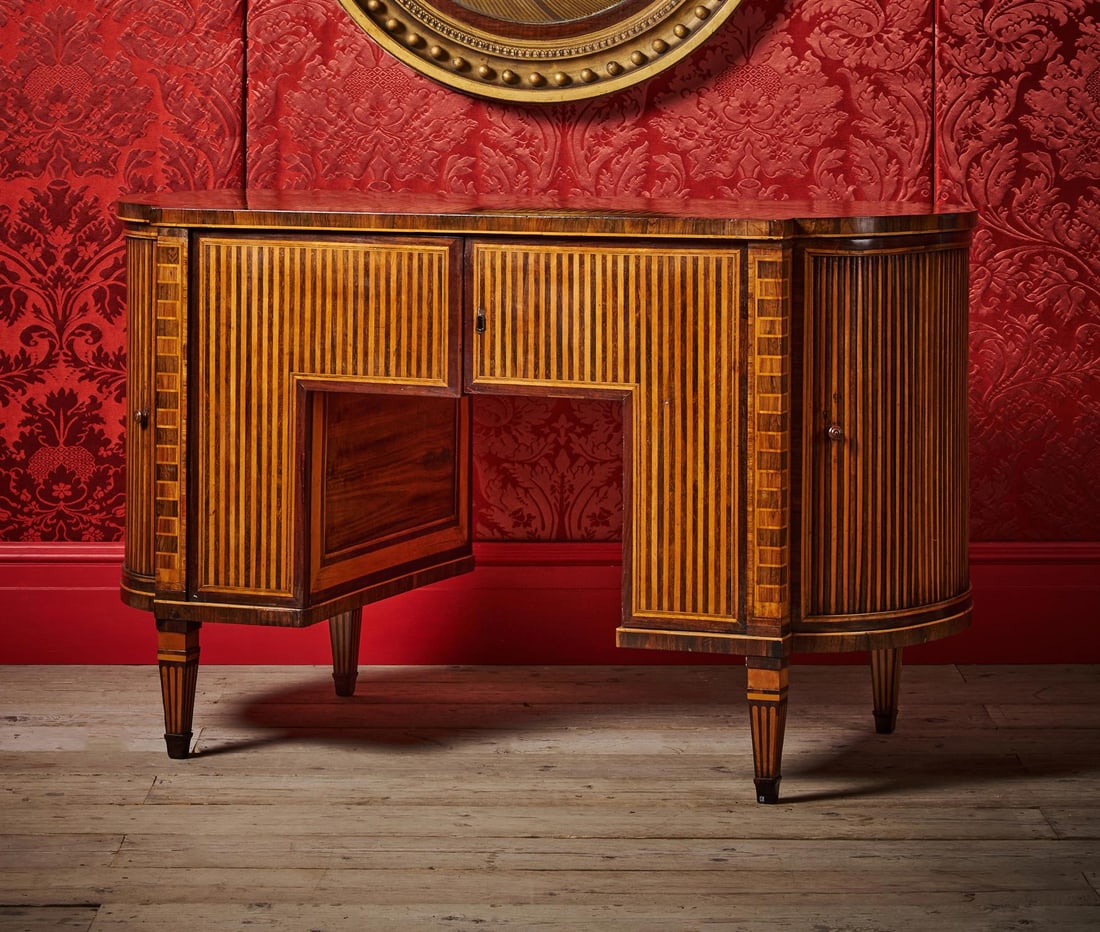 Y AN UNUSUAL ROSEWOOD AND SATINWOOD DESK, POSSIBLY BY AN ÉMIGRÉ MAKER, LATE 18TH OR EARLY: Y AN UNUSUAL ROSEWOOD AND SATINWOOD DESK POSSIBLY BY AN ÉMIGRÉ MAKER, LATE 18TH OR EARLY 19TH CENTURYWith a pair of flush frieze doors opening to a fitted concealed secretaire drawer with in