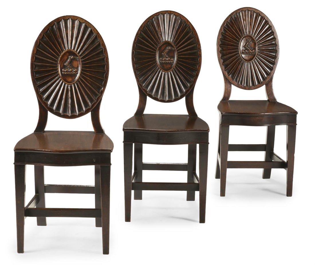 A SET OF THREE GEORGE III CARVED MAHOGANY HALL CHAIRS, IN THE MANNER OF INCE & MAYHEW, CIRCA 1780 (1 of 4)