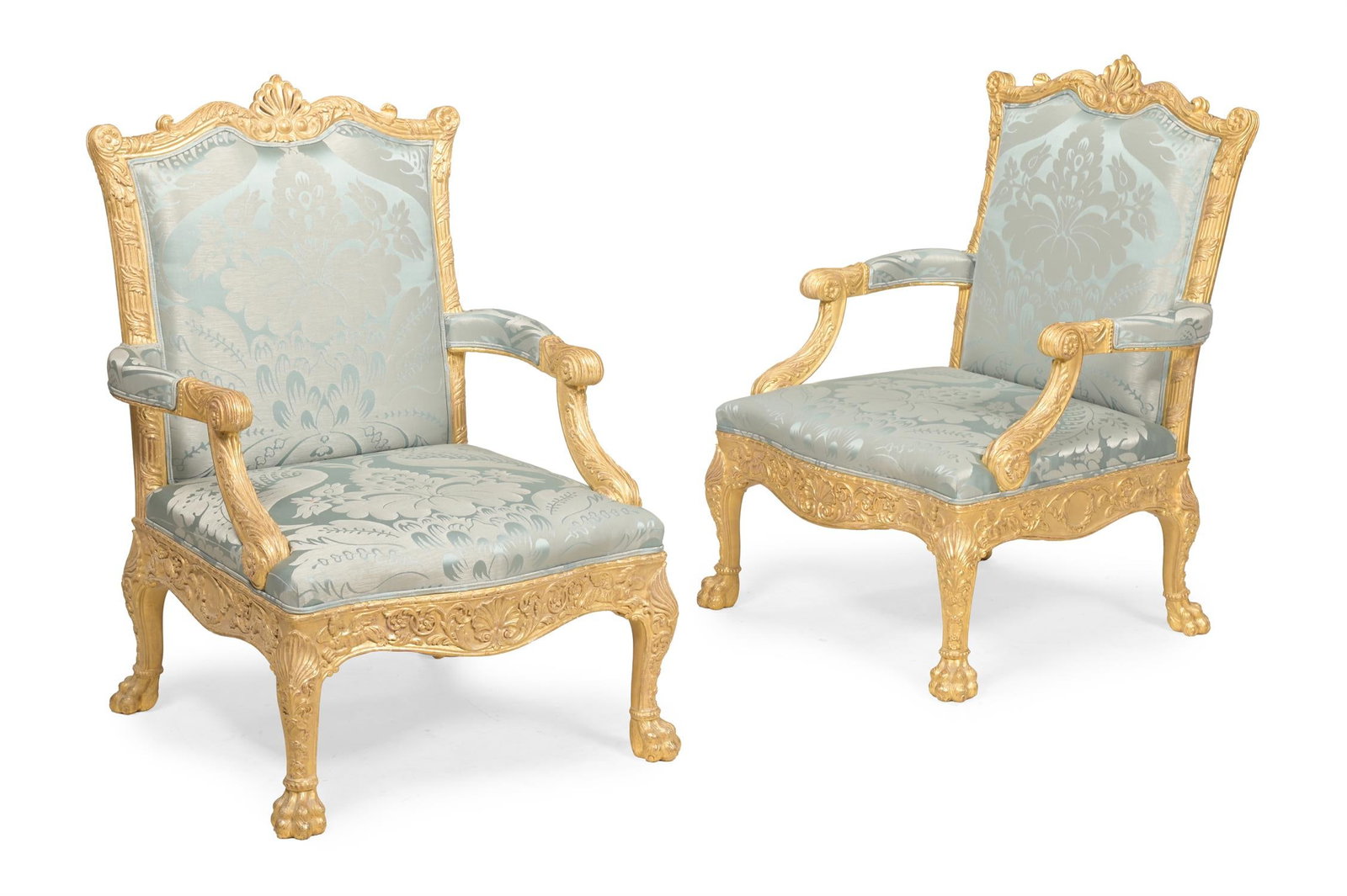 A PAIR OF CARVED GILTWOOD AND UPHOLSTERED LIBRARY ARMCHAIRS, IN GEORGE III STYLE, CONTEMPORARY: A PAIR OF CARVED GILTWOOD AND UPHOLSTERED LIBRARY ARMCHAIRSIN GEORGE III STYLE, CONTEMPORARYAfter the design by Robert Adam and originally manufactured by Thomas Chippendale for the Great Rooms at Arl
