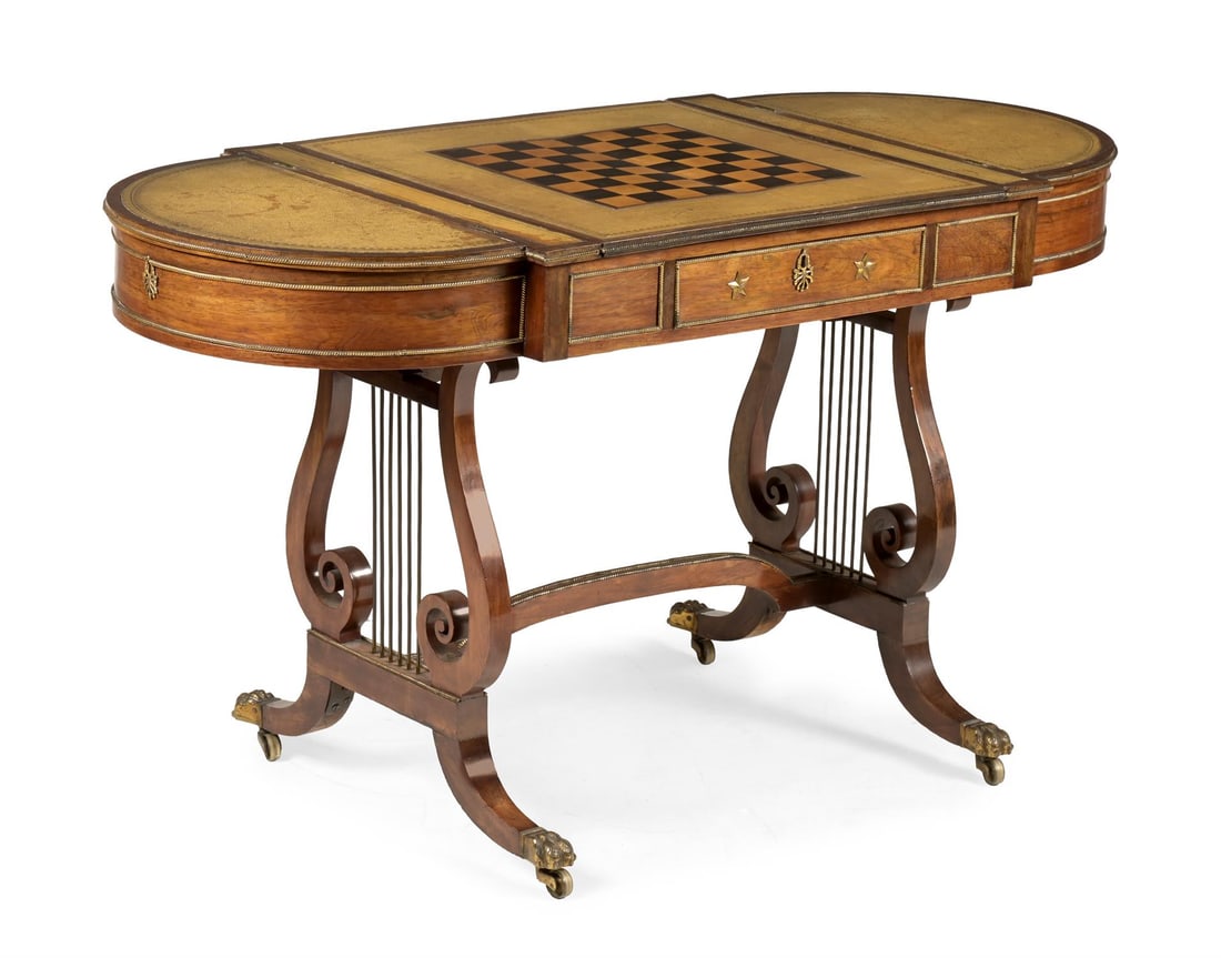 Y A REGENCY ROSEWOOD AND BRASS MOUNTED LIBRARY TABLE, ATTRIBUTED TO GILLOWS, CIRCA 1815: Y A REGENCY ROSEWOOD AND BRASS MOUNTED LIBRARY TABLEATTRIBUTED TO GILLOWS, CIRCA 1815The Morocco leather lined top with hinged end recesses flanking a sliding marquetry chequerboard enclosing a backga
