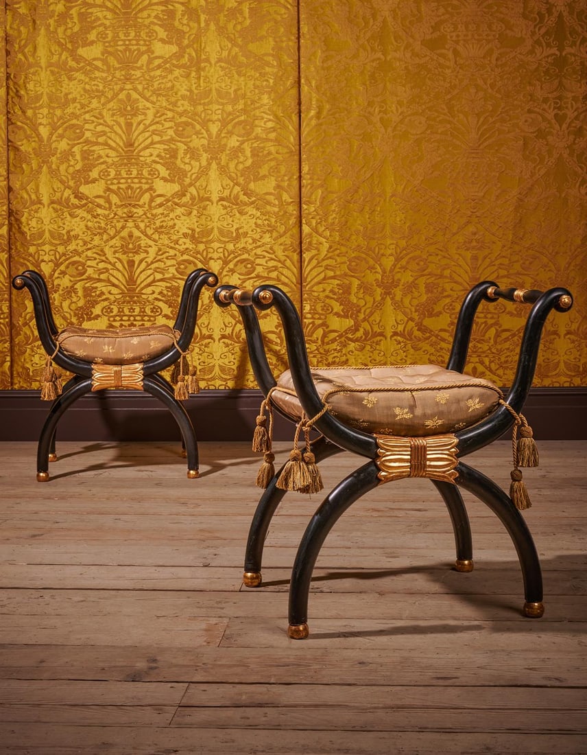 A PAIR OF REGENCY EBONISED AND PARCEL GILT X-FRAME WINDOW SEATS, CIRCA 1815 (1 of 4)