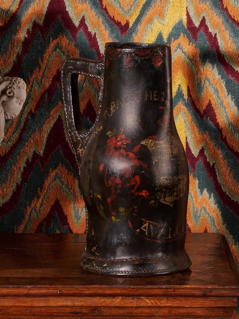 A POLYCHROME DECORATED LEATHER BOMBARD OR 'BLACKJACK' JUG, CIRCA 1700 (1 of 6)