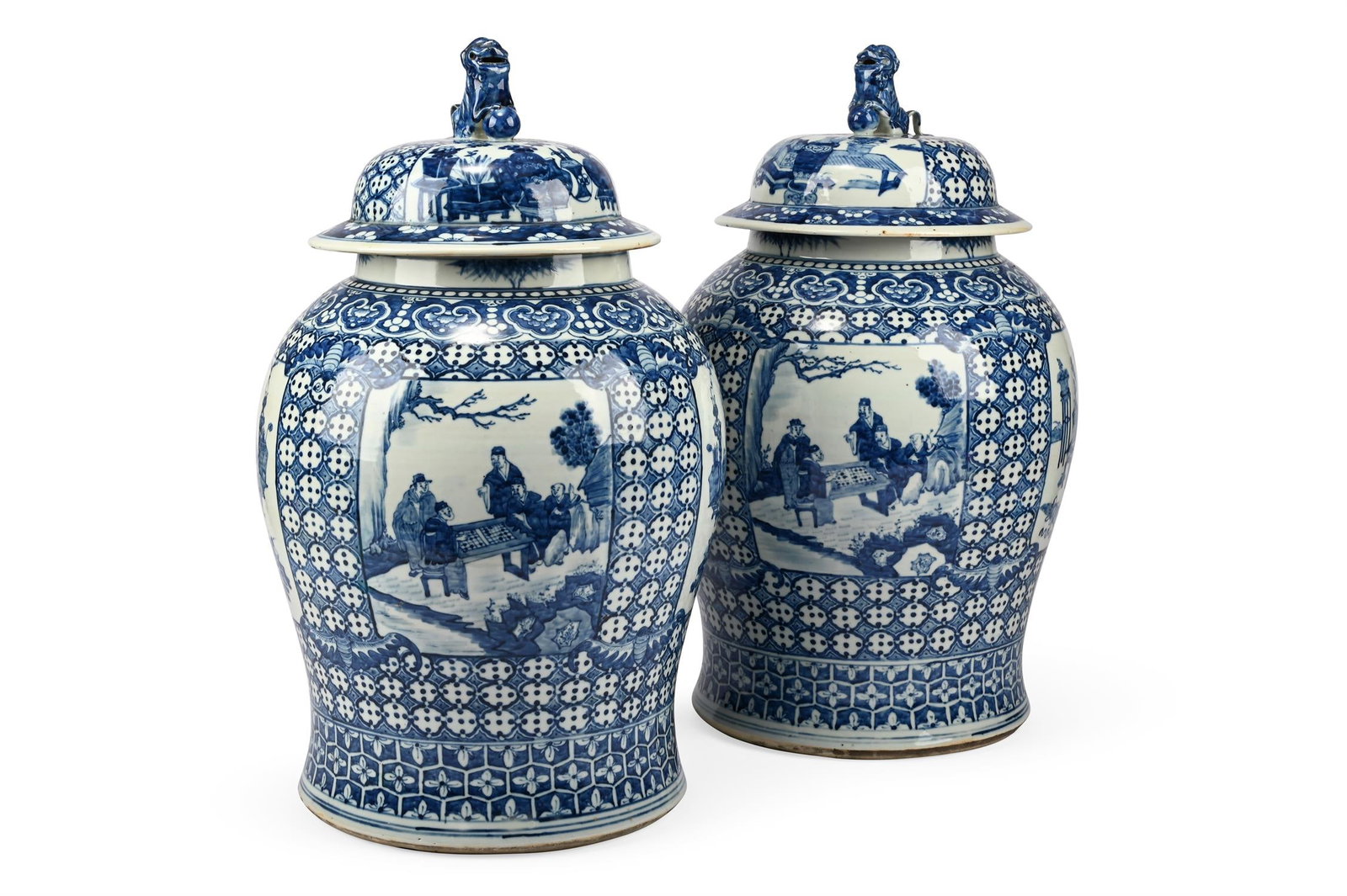 A LARGE PAIR OF CHINESE BLUE AND WHITE VASES AND COVERS, LATE 19TH CENTURY: A LARGE PAIR OF CHINESE BLUE AND WHITE VASES AND COVERS LATE 19TH CENTURY With Shi-Shi dog finials, the bodies with panels of figures within repeating floral banding and stylised chequer design 60cm h