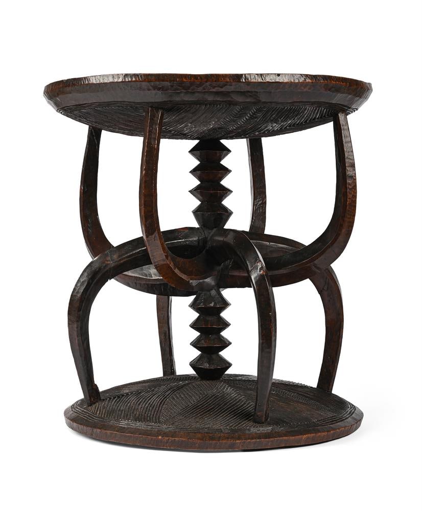 A RARE CARVED IROKO IGBO EKEWE STOOL, SOUTH EASTERN OR SOUTH CENTRAL NIGERIA, CIRCA 1910 - 2