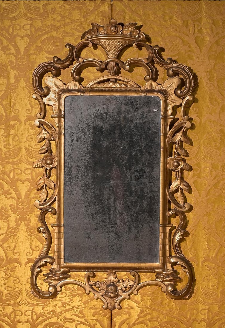 A GEORGE II CARVED GILTWOOD MIRROR, CIRCA 1755 (1 of 3)