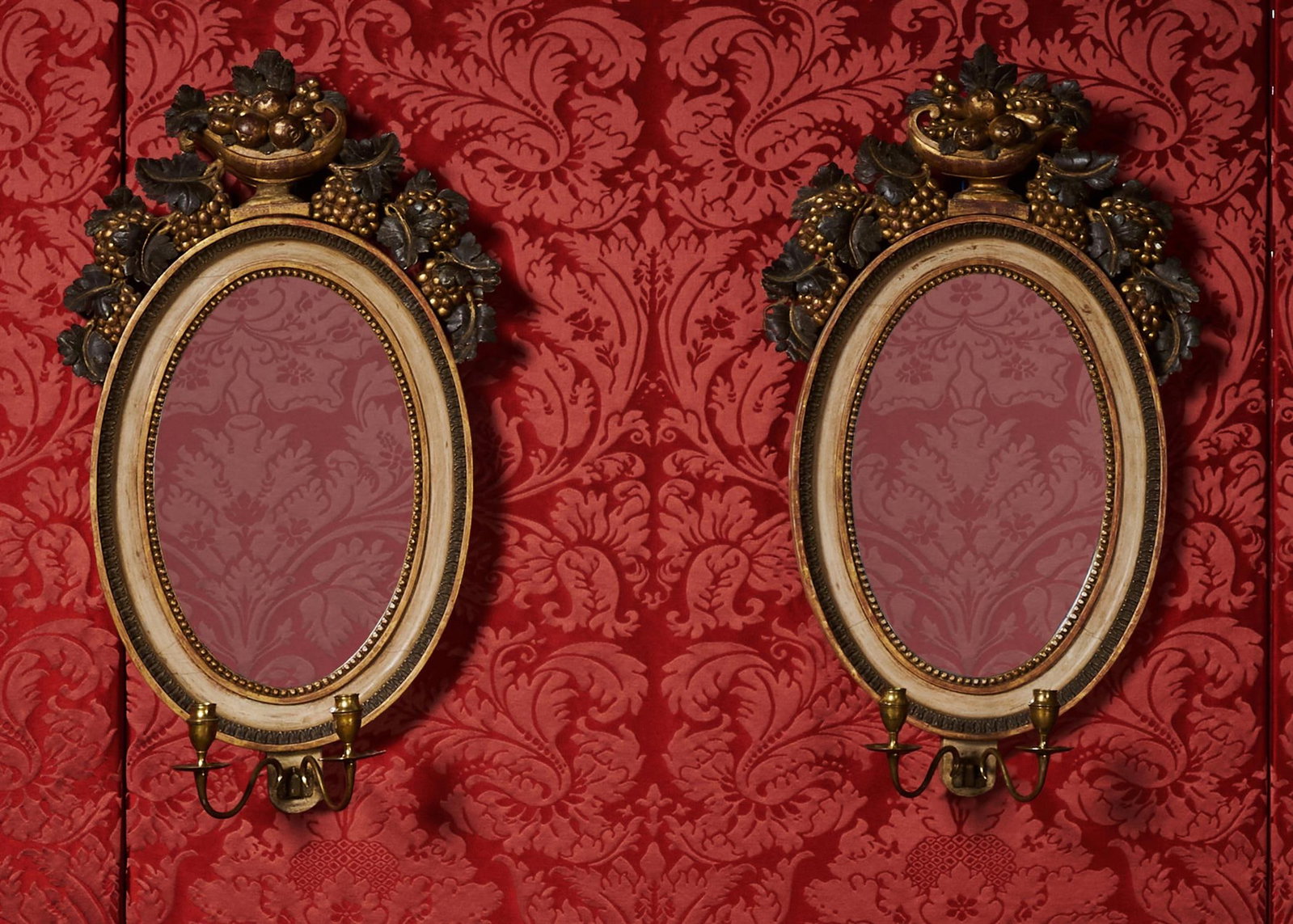 A PAIR OF SWEDISH POLYCHROME PAINTED AND PARCEL GILT OVAL GIRANDOLE MIRRORS, CIRCA 1830 (1 of 4)