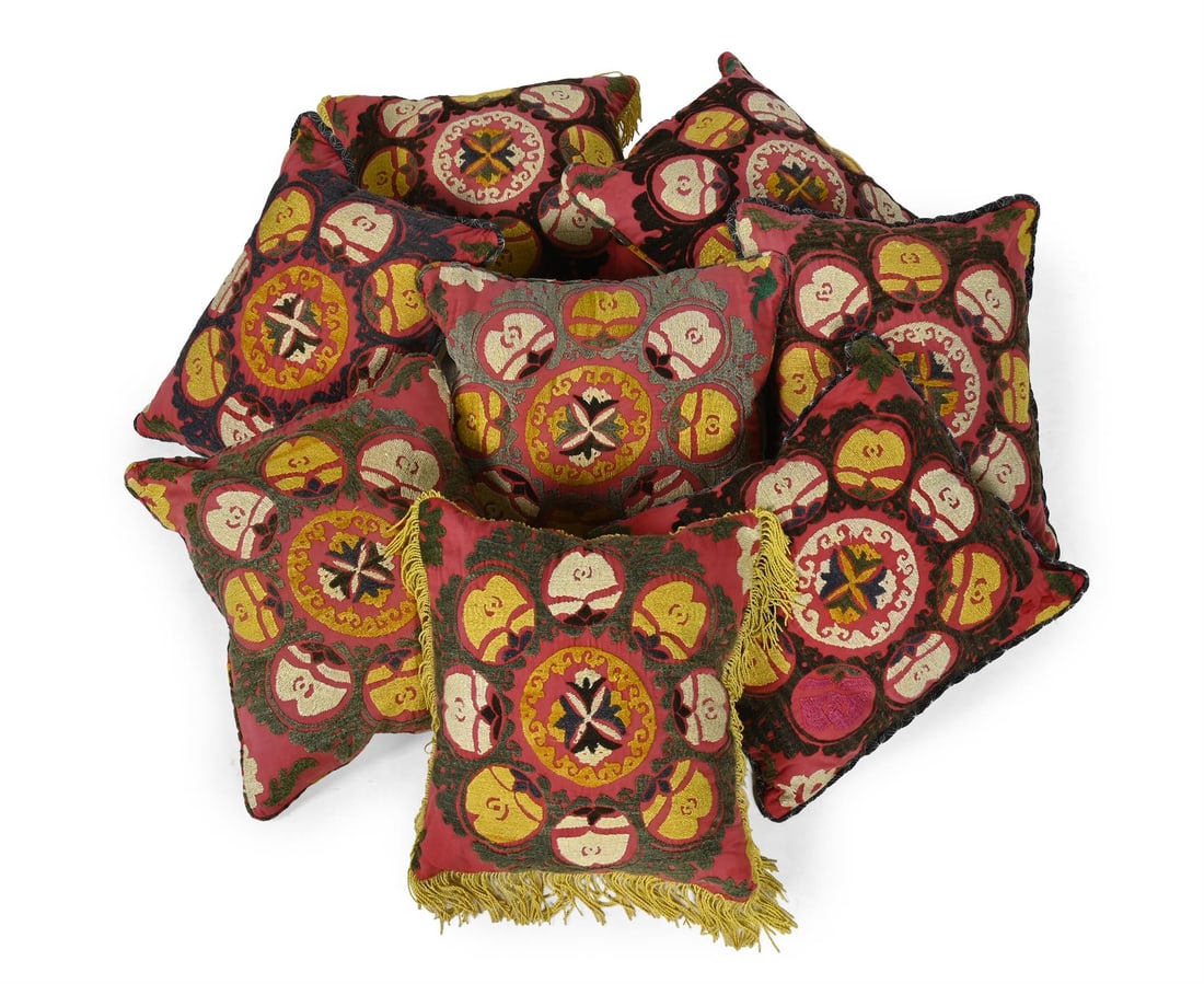 A SET OF EIGHT SUZANI CUSHIONS, 20TH CENTURY USING EARLIER ELEMENTS (1 of 4)