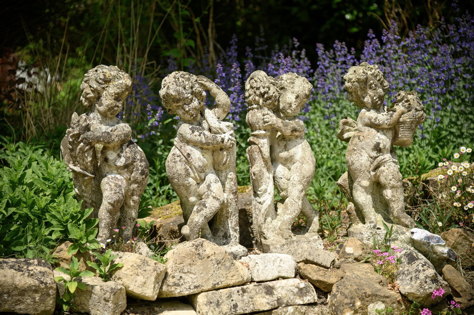 A SET OF FOUR COMPOSITION STONE FIGURES EMBLEMATIC OF THE SEASONS, 20TH CENTURY (1 of 1)
