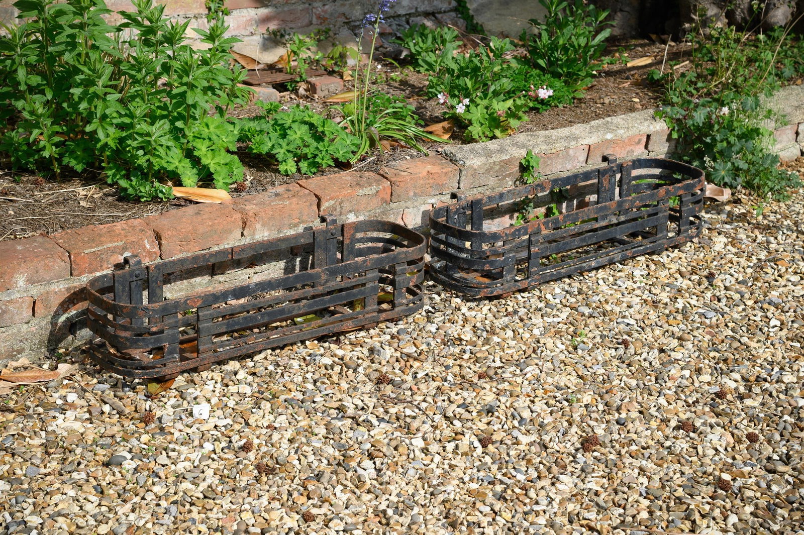 A PAIR OF IRON STRAPWORK HANGING PLANTERS, LATE 19TH OR EARLY 20TH CENTURY (1 of 2)