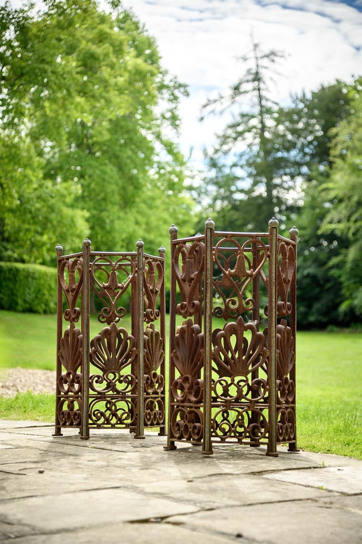 A PAIR OF BRONZE MOUNTED CAST IRON HEXAGONAL PLANTERS OR STICK STANDS, 19TH CENTURY: A PAIR OF BRONZE MOUNTED CAST IRON HEXAGONAL PLANTERS OR STICK STANDS 19TH CENTURY Anthemion and bell flower decoration to the openwork panels, ball finials, formerly with liners 79cm high, 46cm wide