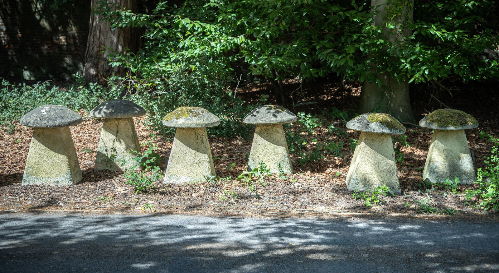 A SET OF SIX COMPOSITION STONE STADDLE STONES, 20TH CENTURY (1 of 2)