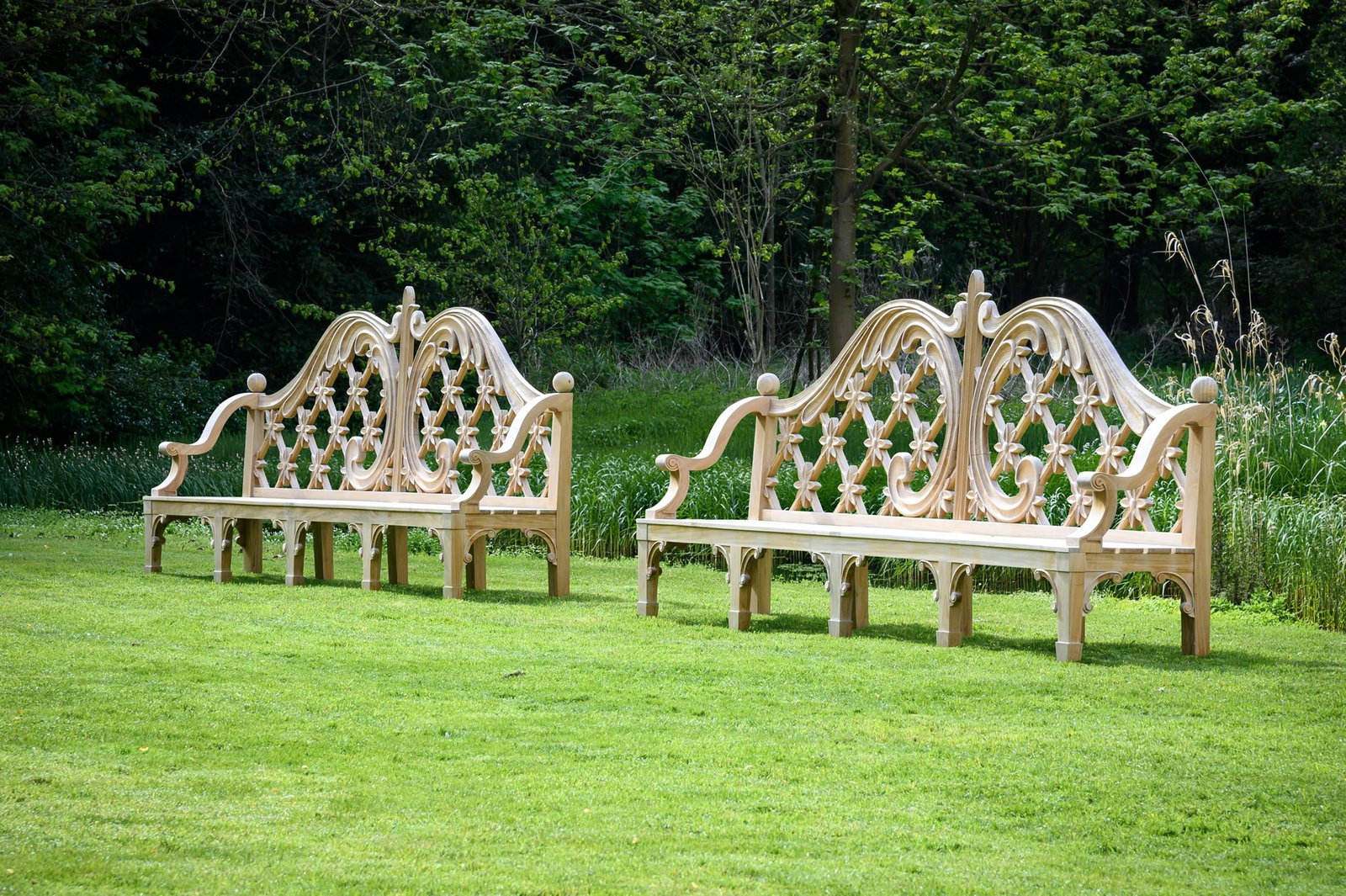A LARGE PAIR OF CARVED TEAK LATTICE BACK GARDEN BENCHES, CONTEMPORARY (1 of 1)