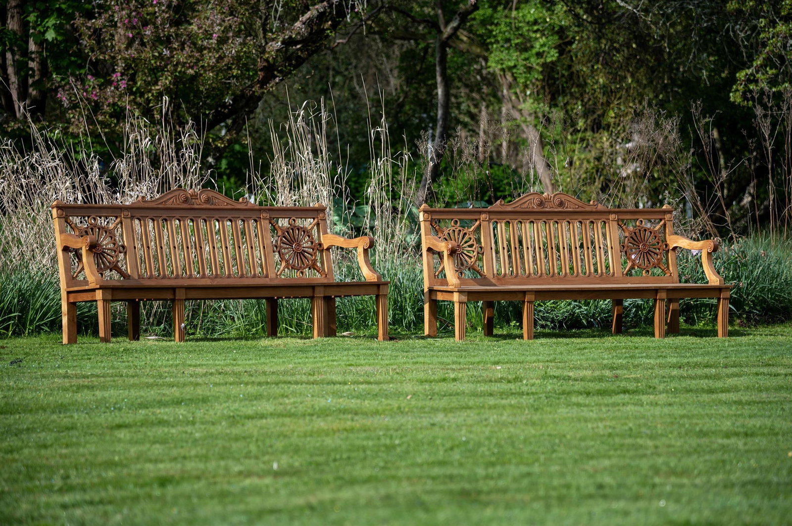 A PAIR OF CARVED TEAK 'HAREWOOD' GARDEN BENCHES, CONTEMPORARY (1 of 2)