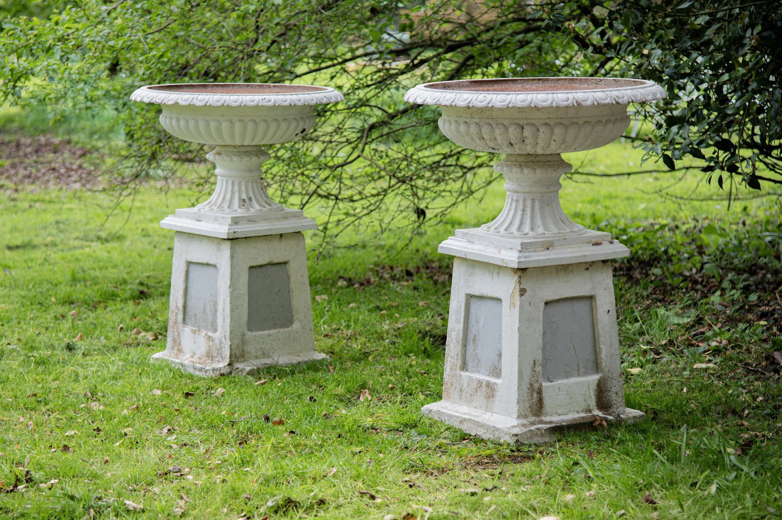 A LARGE PAIR OF CAST IRON FLUTED PEDESTAL URNS, 19TH CENTURY (1 of 2)