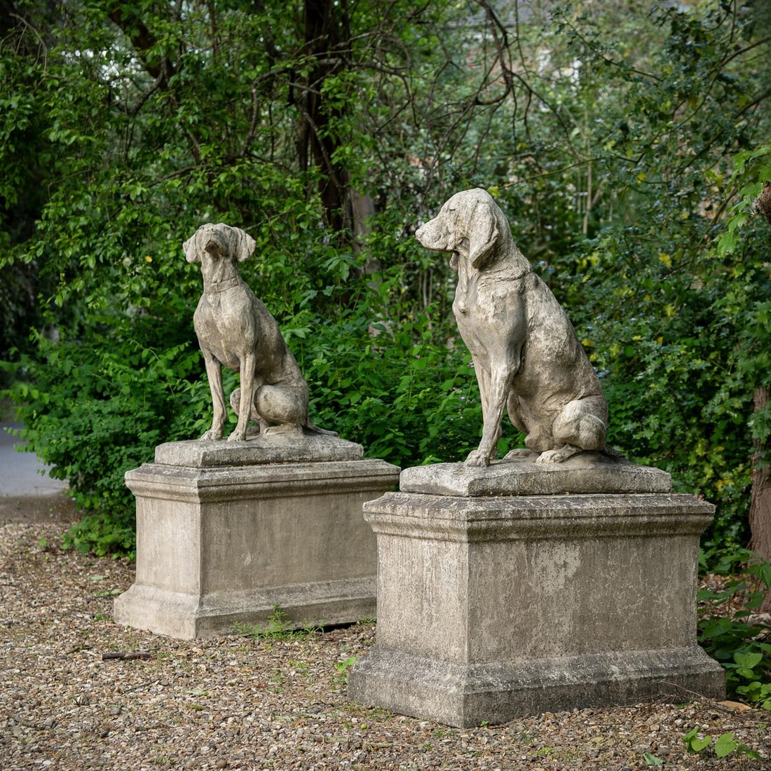 A PAIR OF STONE COMPOSITION MODELS OF SEATED HOUNDS ON PLINTHS, 20TH CENTURY (1 of 4)