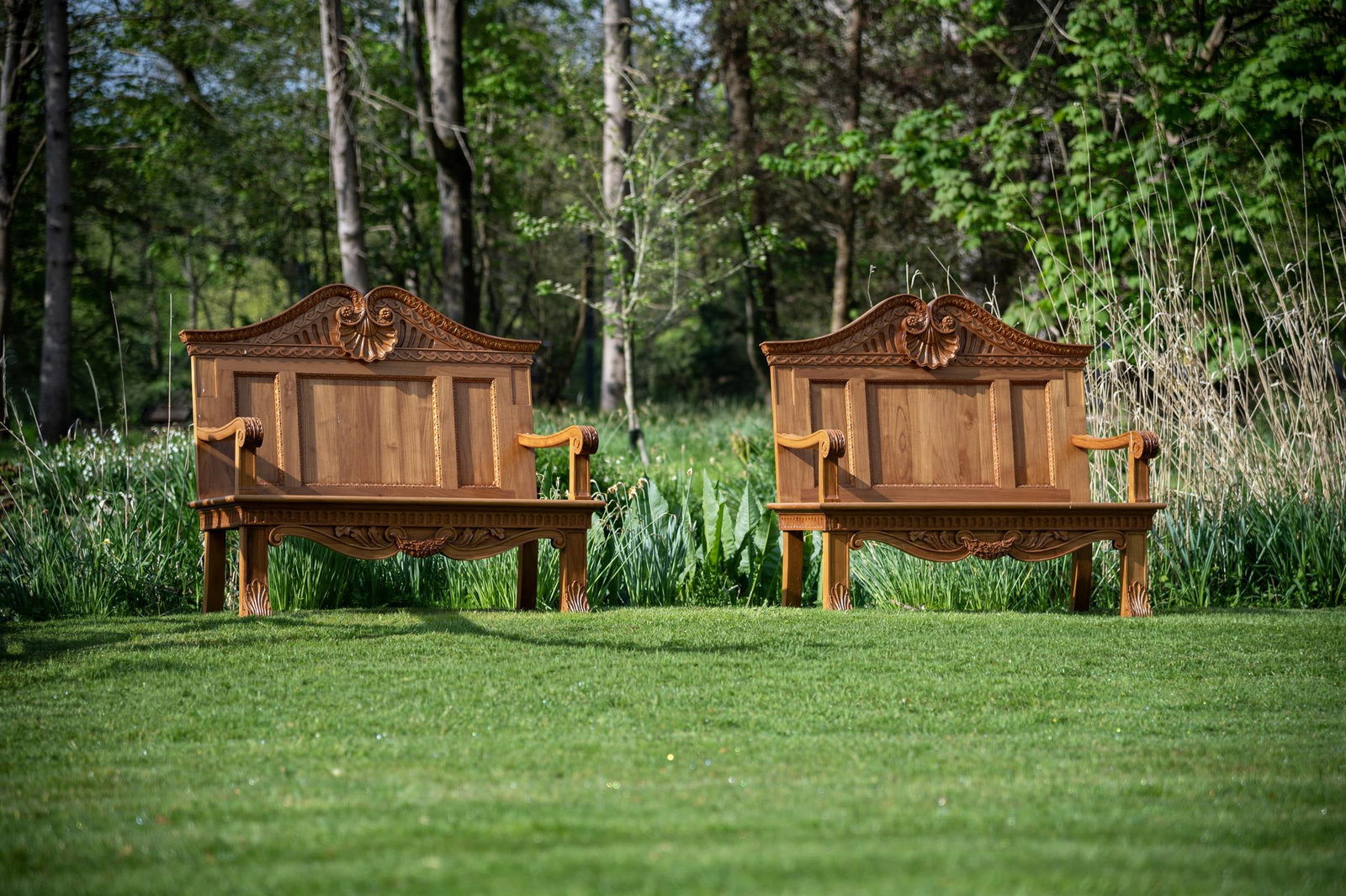 A PAIR OF CARVED TEAK GARDEN BENCHES, IN THE MANNER OF WILLIAM KENT, CONTEMPORARY (1 of 1)