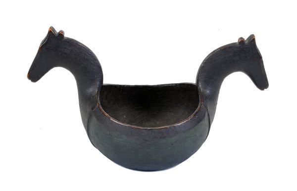 A Scandinavian, probably Norwegian carved and pain: A Scandinavian, probably Norwegian carved and painted wood twin handled kasa, mid 19th century, the handles modelled as horses' heads and rising up from shield shaped panels in low relief on the bowl,