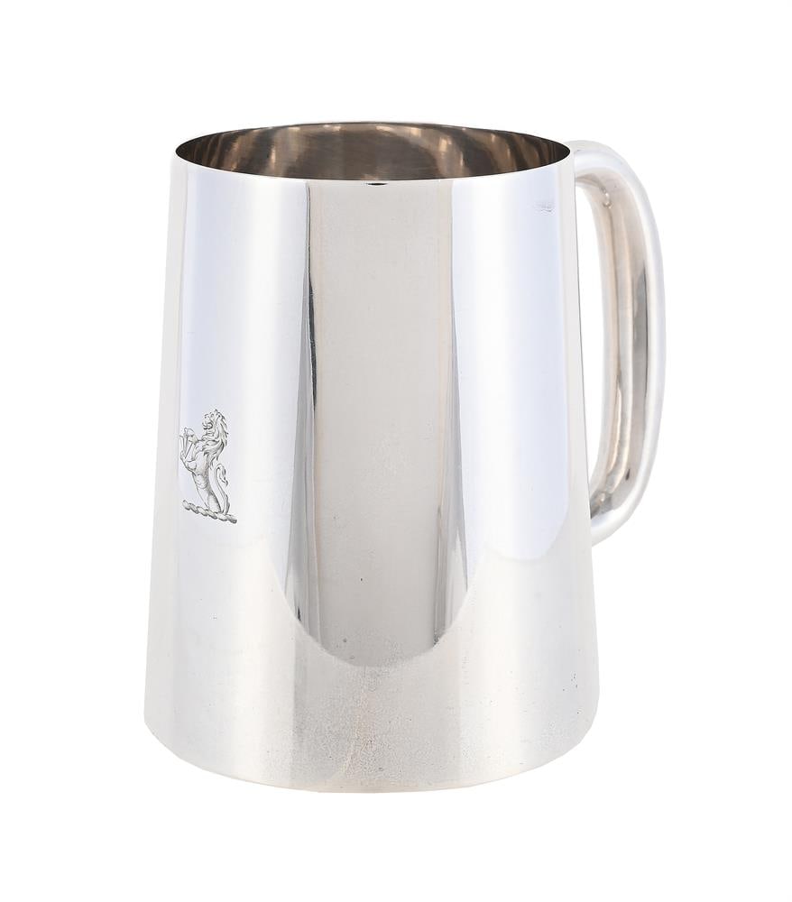 A SILVER TAPERING MUG: A SILVER TAPERING MUG J. DIXON & SONS, SHEFFIELD 1943 With a C-clip handle and engraved with a crest 9.5cm high 215g (6.9 oz) Condition Report: Marks are clear Crest crisp Slightly wobbles Light