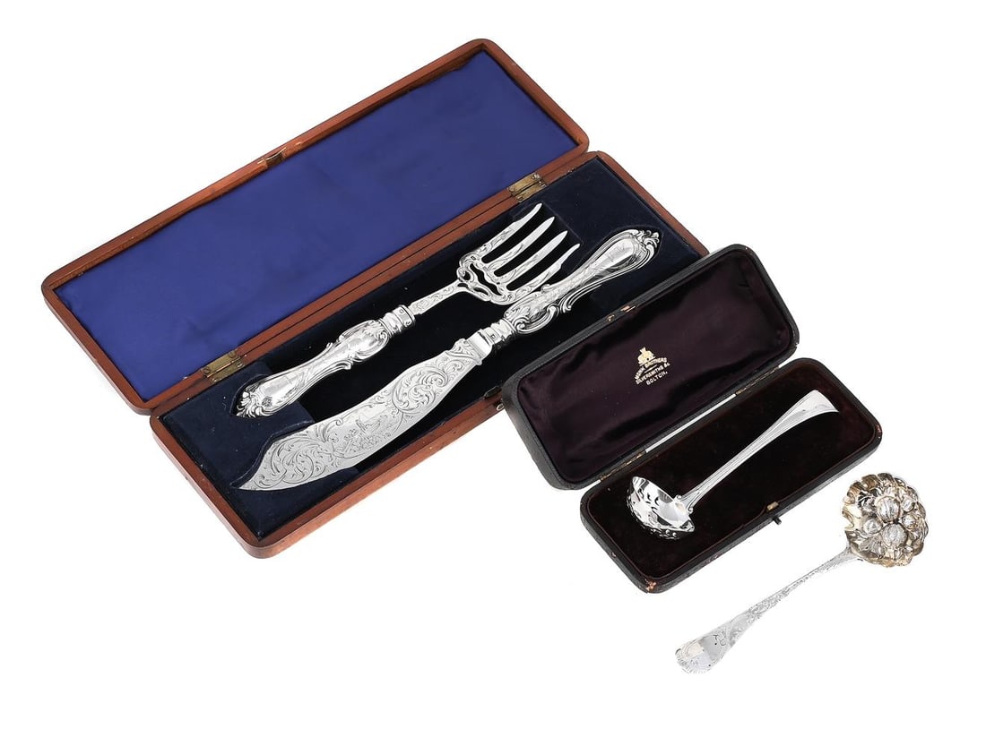 A CASED PAIR OF VICTORIAN SILVER FISH SERVERS AND TWO SIFTING SPOONS: A CASED PAIR OF VICTORIAN SILVER FISH SERVERS AARON HATFIELD & SONS, SHEFFIELD 1851 Engraved with foliage and a crest, the blade with a fishing scene The knife 32cm long Loaded Together with: A
