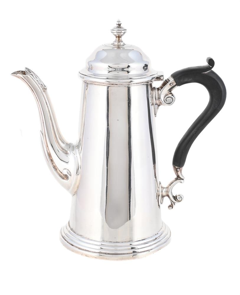 A SILVER TAPERING COFFEE POT: A SILVER TAPERING COFFEE POT HARRISON BROTHERS & HOWSON (GEORGE HOWSON), SHEFFIELD 1934 With a compressed orb finial to the ogee domed cover, a wood scroll handle and on a circular moulded
