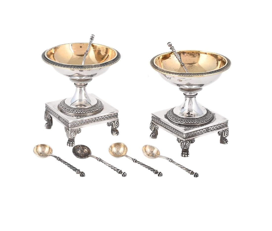 A PAIR OF FRENCH SILVER PEDESTAL SALTS: A PAIR OF FRENCH SILVER PEDESTAL SALTS PARIS, 1819 - 1838 .950 STANDARD With tongue and dart borders, knopped stems, to square bases and on four paw feet 7cm high Together with: SIX SILVER COLOURED