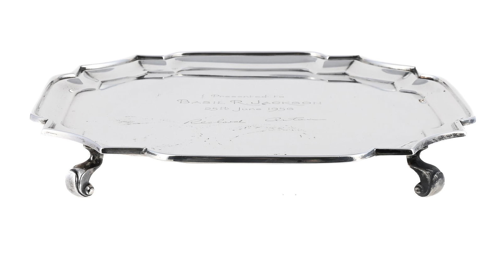 A SILVER SHAPED SQUARE SALVER: A SILVER SHAPED SQUARE SALVER GOLDSMITHS & SILVERSMITHS CO. LTD., LONDON 1916 With a raised moulded border, engraved 'Presented to Basil R. Jackson 25th June 1956', on four scroll feet
