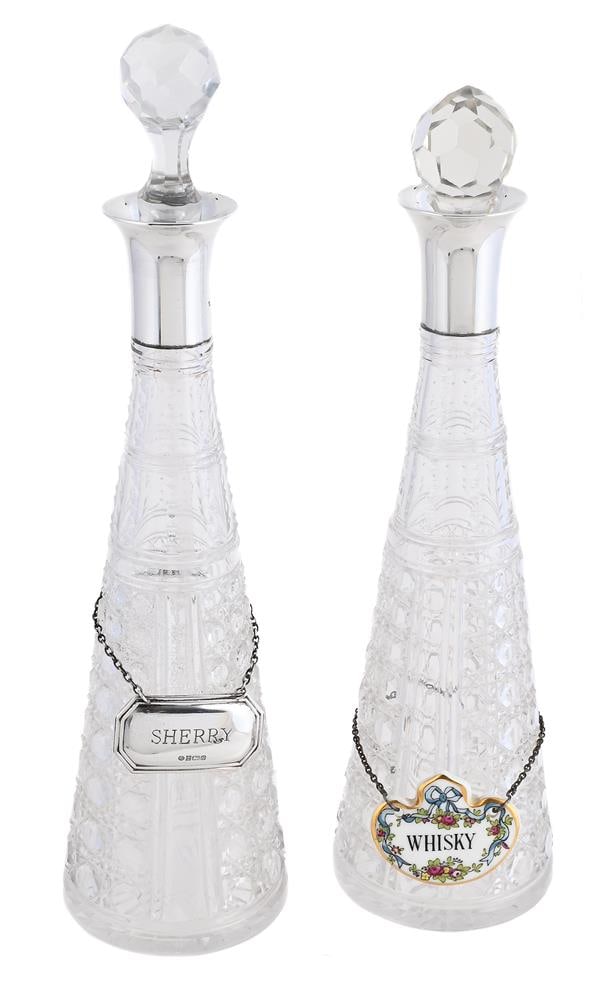 A PAIR OF FRENCH SILVER MOUNTED AND CUT GLASS DECANTERS: A PAIR OF FRENCH SILVER MOUNTED AND CUT GLASS DECANTERS MAKER'S MARK JBF, .925 STANDARD MINERVA MARK With silver collars, cut glass bodies and stoppers, one with a silver decanter label by Ray