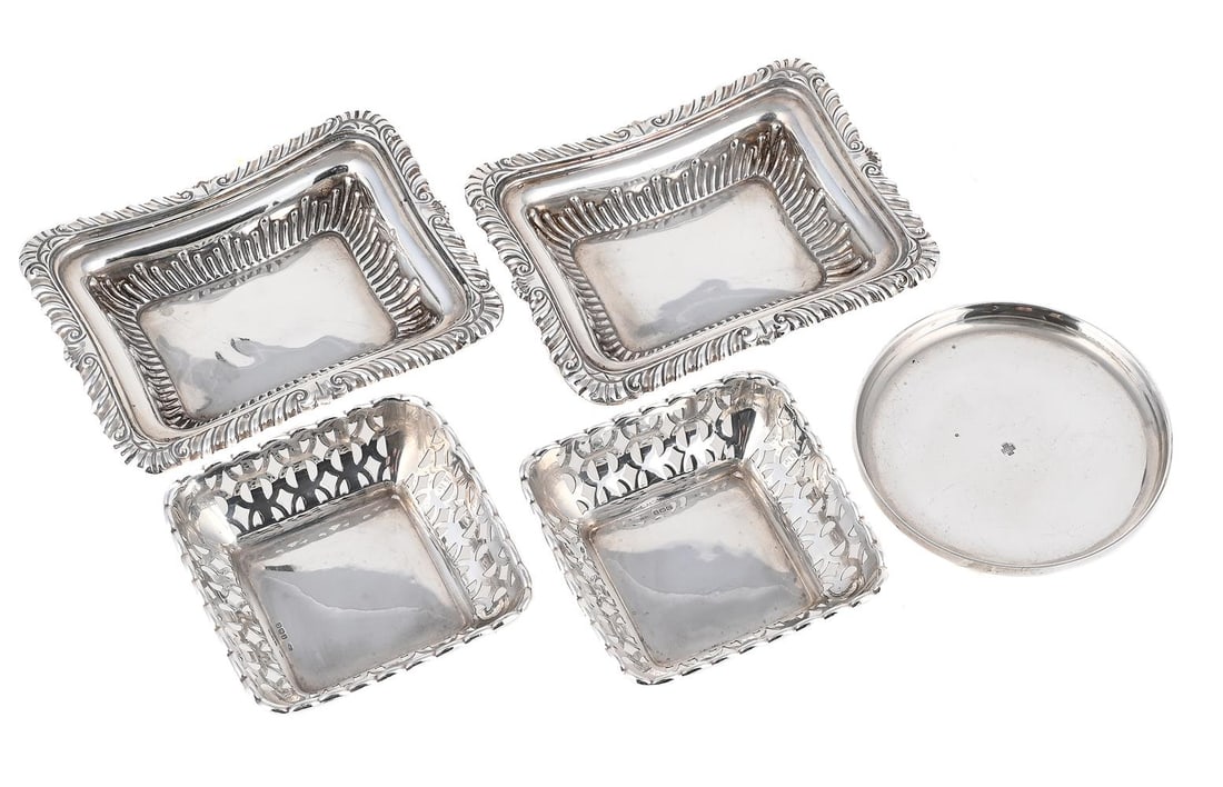 A COLLECTION OF SILVER DISHES: A MATCHED PAIR OF VICTORIAN SILVER SHAPED RECTANGULAR DISHES WILLIAM AITKEN, CHESTER 1896 AND EDWARD BARNARD & SONS LTD., LONDON 1898 With gadrooned and shell borders 13.5cm long Together with: A