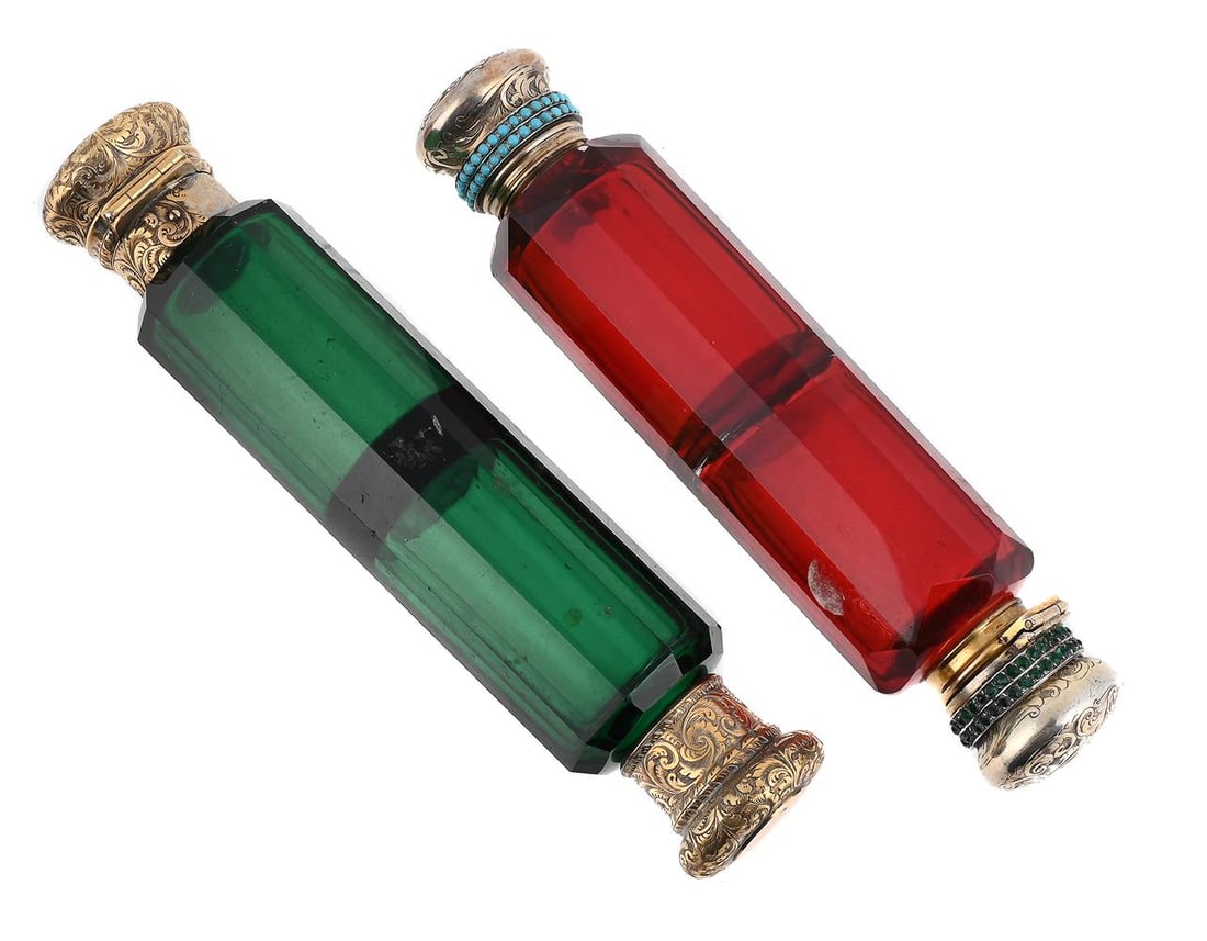 TWO GLASS SCENT BOTTLES: A GILT METAL MOUNTED AND GREEN GLASS SCENT BOTTLE GIBBONS, MARKET STREET, MANCHESTER The covers engraved with foliate swags and circular vacant reserves 15cm long Together with: A GILT METAL MOUNTED