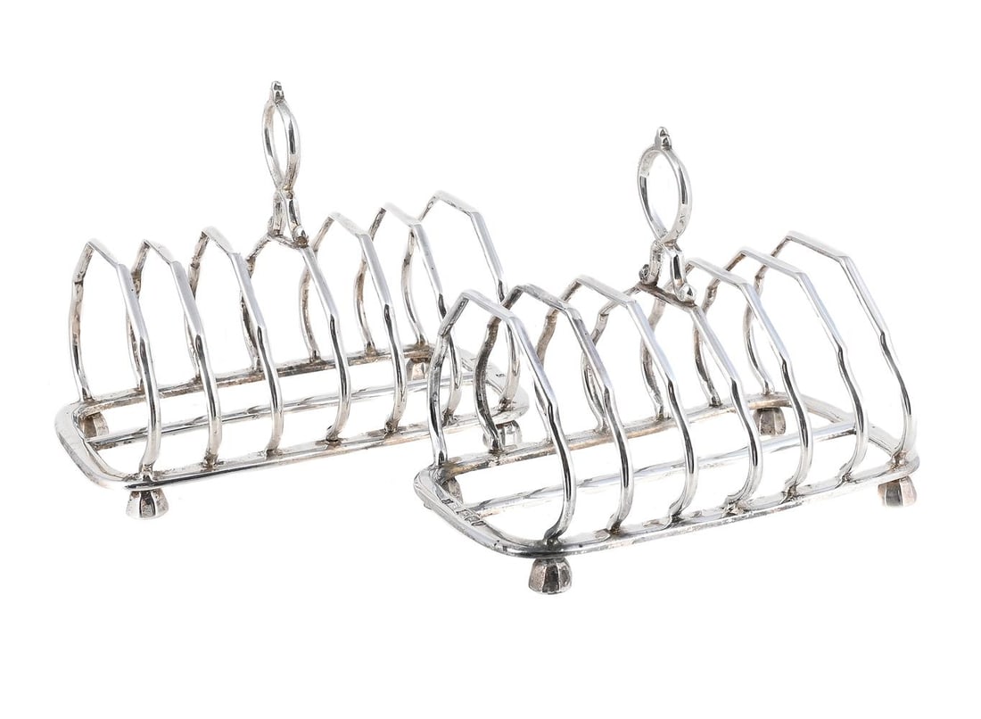A PAIR OF VICTORIAN SILVER SIX DIVISION TOAST RACKS: A PAIR OF VICTORIAN SILVER SIX DIVISION TOAST RACKS HENRY WILKINSON & CO., LONDON 1895 With loop handles and on facetted dome feet 13.5cm long 431g (13.9 oz)