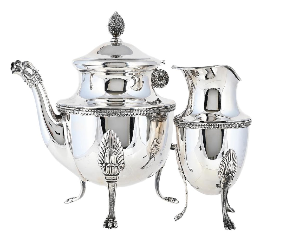 AN ITALIAN SILVER TEA POT AND MILK JUG: AN ITALIAN SILVER TEA POT AND MILK JUG ALESSANDRIA 1944 - 1968 .800 STANDARD The tea pot with a bud finial to the domed cover, a tongue and dart border, on three paw feet 22.5cm high 1103g (35.45 oz)