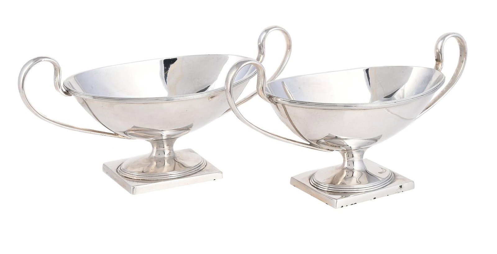 A PAIR OF SILVER TWIN HANDLED OVAL PEDESTAL SALTS: A PAIR OF SILVER TWIN HANDLED OVAL PEDESTAL SALTS