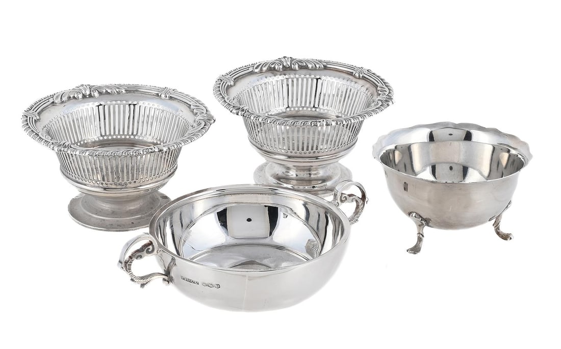 A CASED SILVER JERSEY BOWL, A PAIR OF PIERCED DISHES AND ANOTHER BOWL: A CASED SILVER REPLICA JERSEY BOWL E. J. GALLICHAN & CO. LTD., SHEFFIELD 1938 With twin scroll handles 15cm long Together with: A PAIR OF VICTORIAN SILVER CIRCULAR PEDESTAL DISHES WILLIAM COMYNS