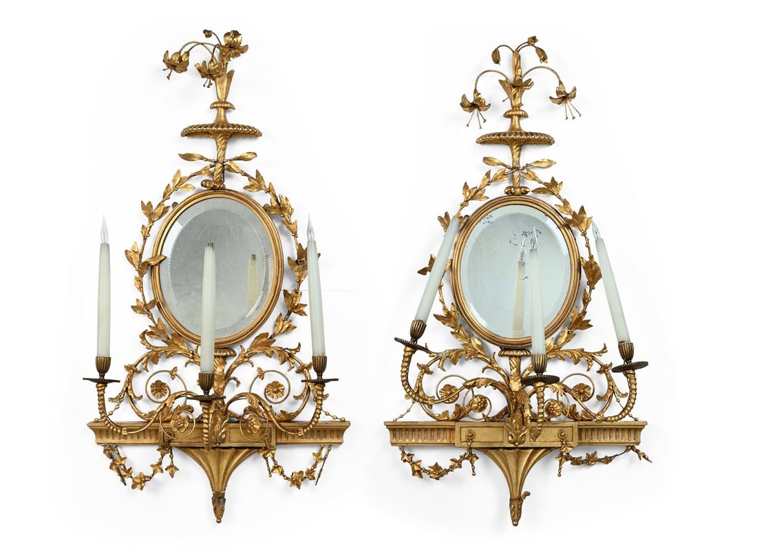 A PAIR OF GILTWOOD AND COMPOSITION, TRIPLE BRANCH, MIRROR BACK WALL APPLIQUES, 19TH CENTURY: A PAIR OF GILTWOOD AND COMPOSITION TRIPLE BRANCH MIRROR BACK WALL APPLIQUES IN THE MANNER OF ROBERT ADAM, 19TH CENTURY And later fitted for electricity 104cm high, 56cm wide Condition Report: