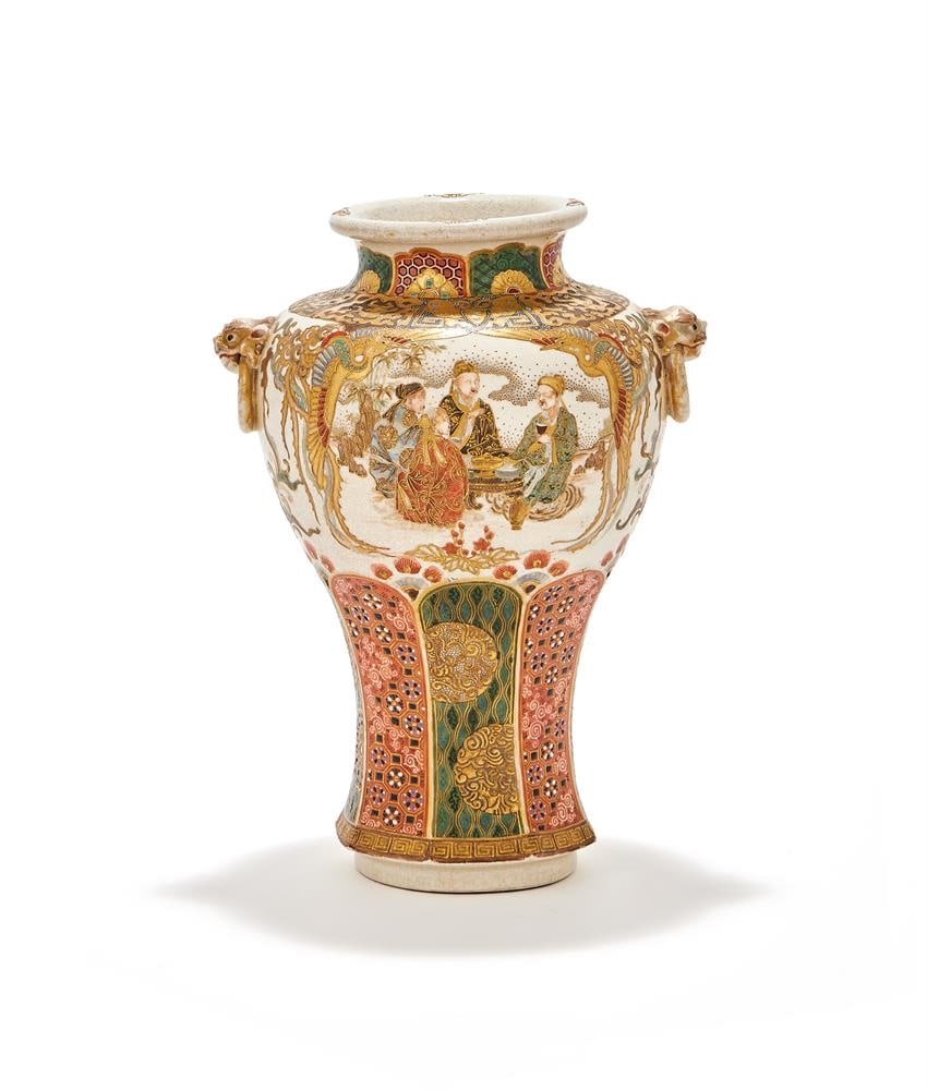 A JAPANESE SATSUMA VASE, MEIJI PERIOD: A JAPANESE SATSUMA VASE MEIJI PERIOD The tapering ovoid body with mask and ring handles, painted with scenes of figures to each side above complex gilt, iron-red and enamelled borders 23cm high