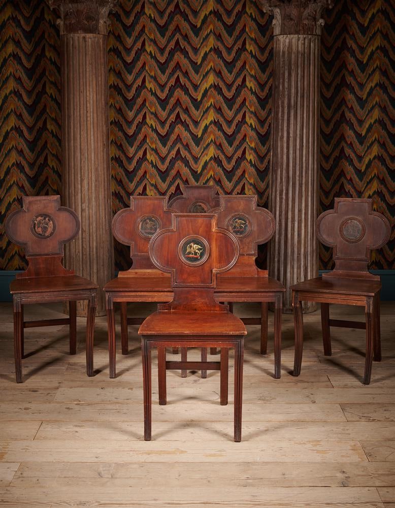 A SET OF SIX REGENCY MAHOGANY HALL CHAIRS, CIRCA 1820: A SET OF SIX REGENCY MAHOGANY HALL CHAIRS CIRCA 1820 With a central painted armorial for the crest of Nugent 85.5cm high, 42cm wide, 45.5cm deep