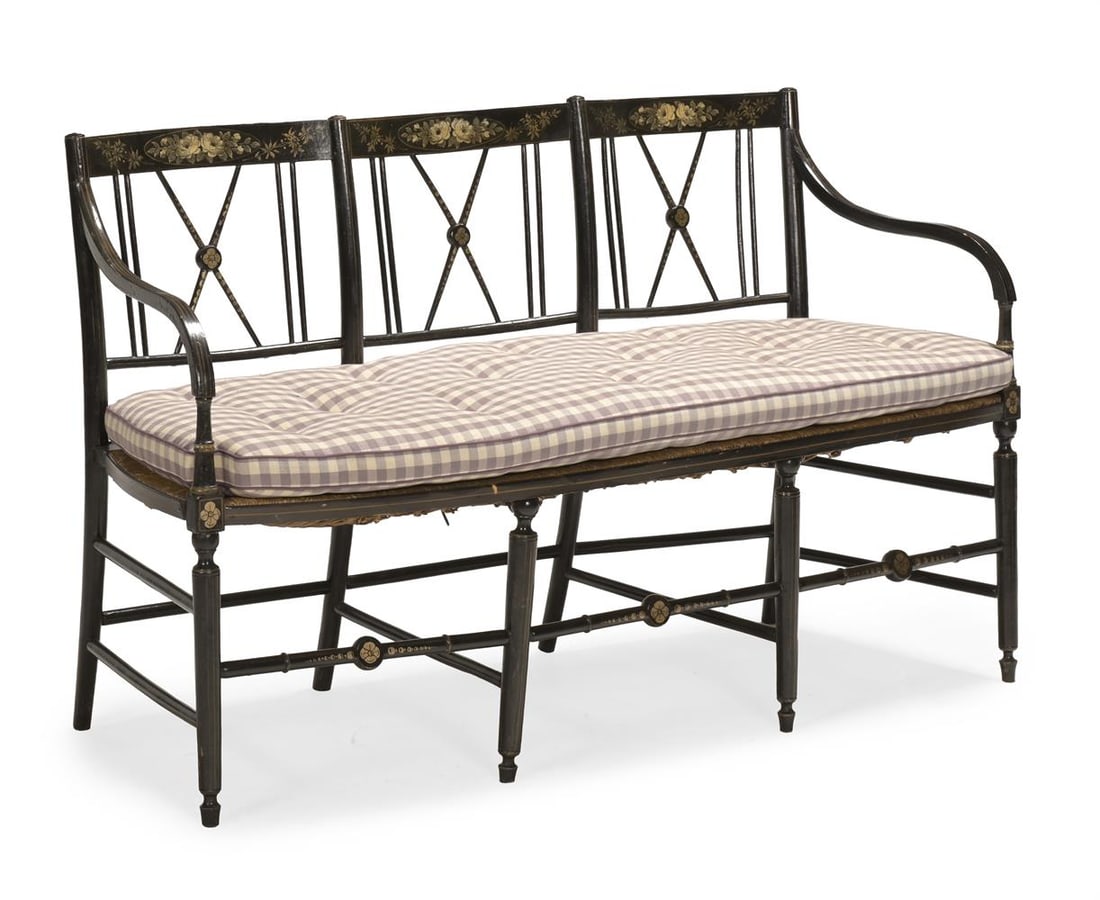 A REGENCY STYLE EBONISED AND PARCEL GILT TRIPLE CHAIR BACK SETTEE, FIRST QUARTER 19TH CENTURY: A REGENCY STYLE EBONISED AND PARCEL GILT TRIPLE CHAIR BACK SETTEE THIRD QUARTER 19TH CENTURY Seat cushion upholstered in Colefax & Fowler's 'Appledore Check' each 83cm high, 140cm