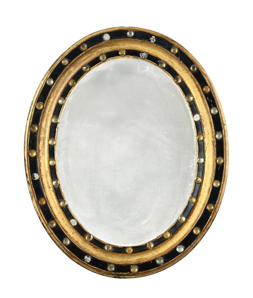 AN IRISH REGENCY OVAL WALL MIRROR, EARLY 19TH CENTURY: AN IRISH REGENCY OVAL WALL MIRROR EARLY 19TH CENTURY Decorated with faceted glass studs applied to ebonised bands 51cm high, 41cm wide Condition Report: PLEASE NOTE: ALL LOTS ARE LOCATED AT SACKVILLE