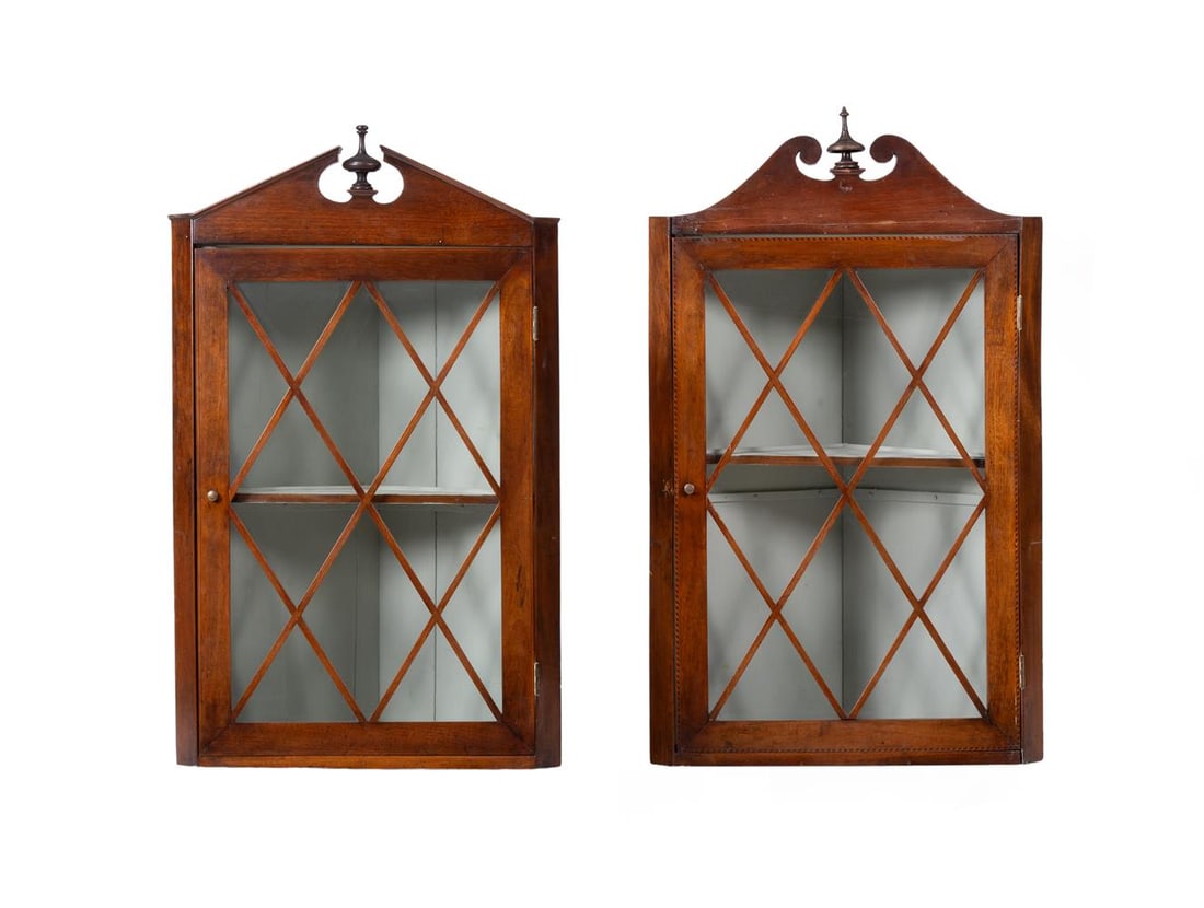 A MATCHED PAIR OF GEORGE III GLAZED HANGING CORNER CUPBOARDS, CIRCA 1800: A MATCHED PAIR OF GEORGE III GLAZED HANGING CORNER CUPBOARDS CIRCA 1800 Each with a single glazed door 100cm high, 63cm wide, 38cm deep Condition Report: PLEASE NOTE: ALL LOTS ARE LOCATED AT