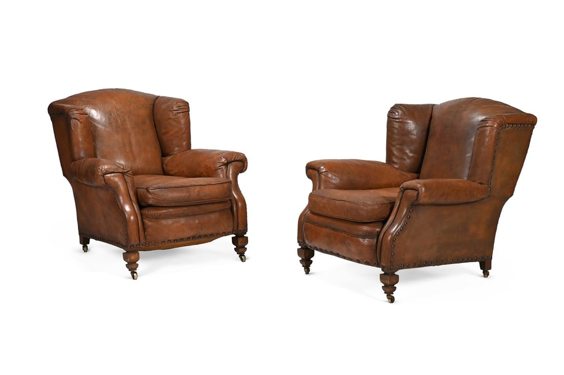 A PAIR OF EDWARDIAN BROWN HIDE UPHOSTERED WING ARMCHAIRS, BY S. J. WARING, CIRCA 1902 (1 of 3)
